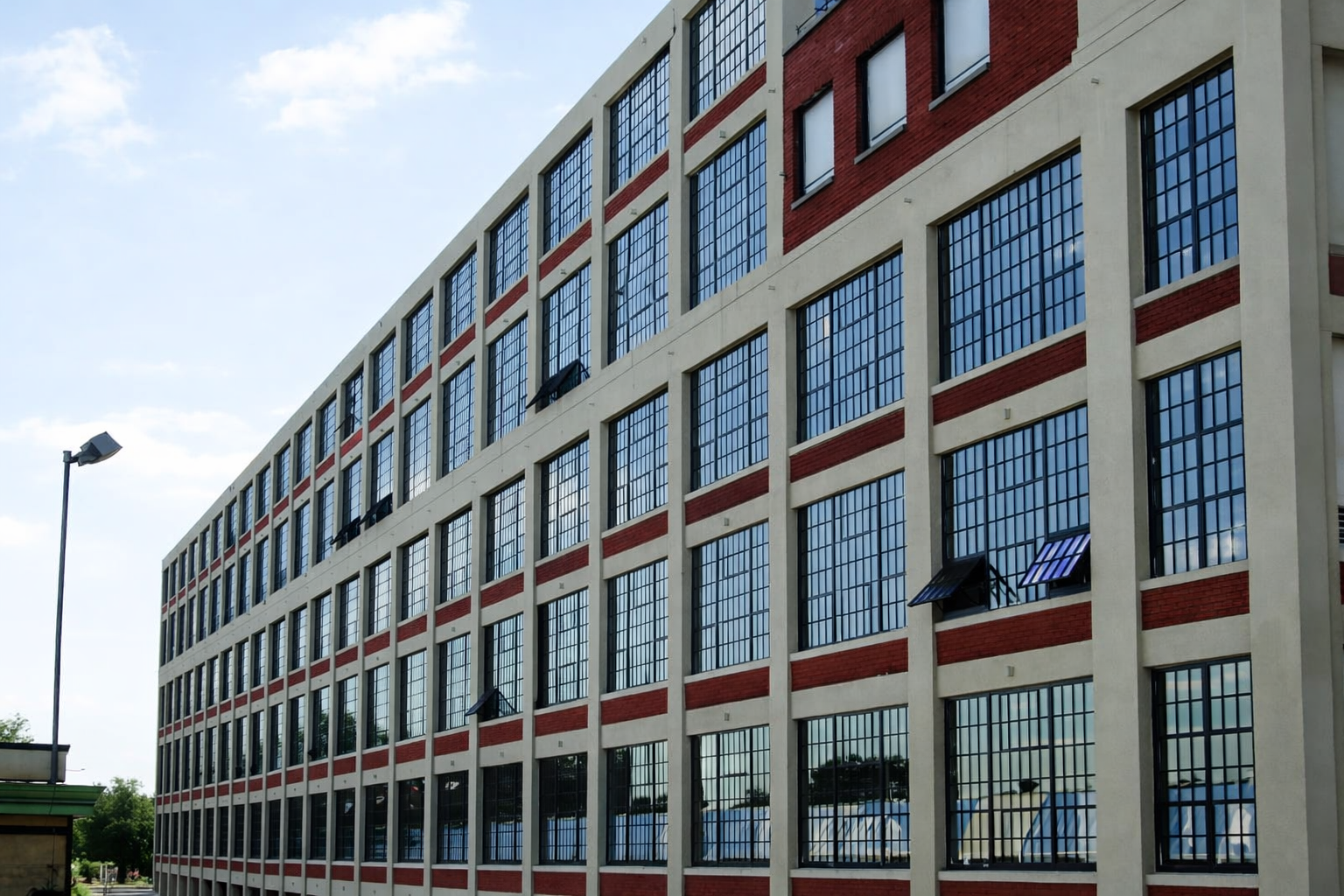 Restored industrial windows following completion of masonry and façade repairs.